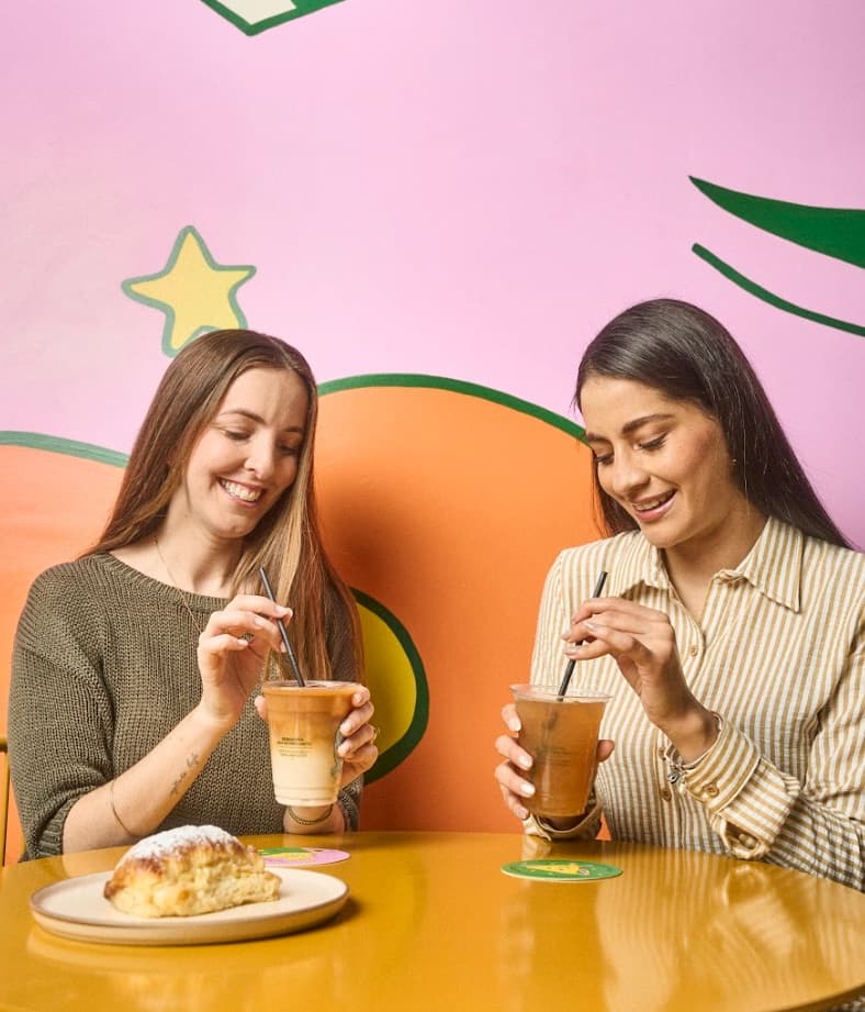 Adults sharing coffee at Zim y Züm